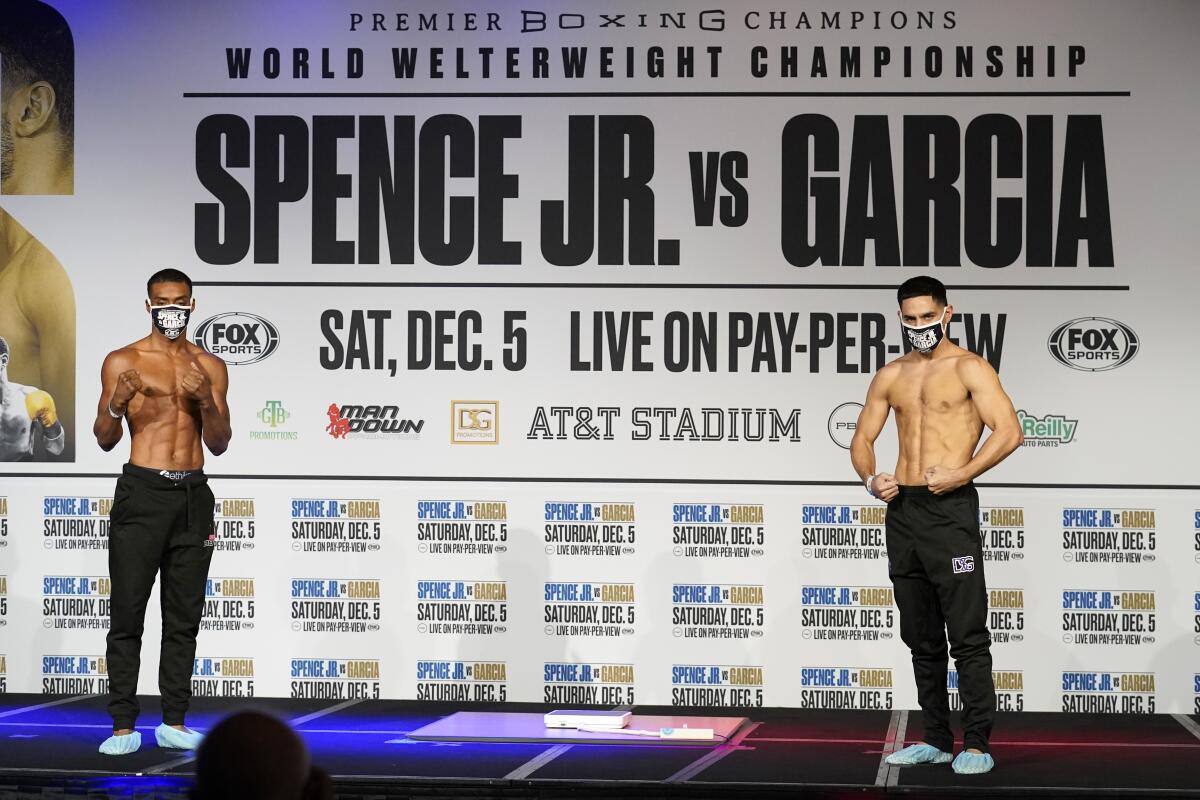 Errol Spence Jr., left, and Danny Garcia pose on stage after their weigh-ins Friday.