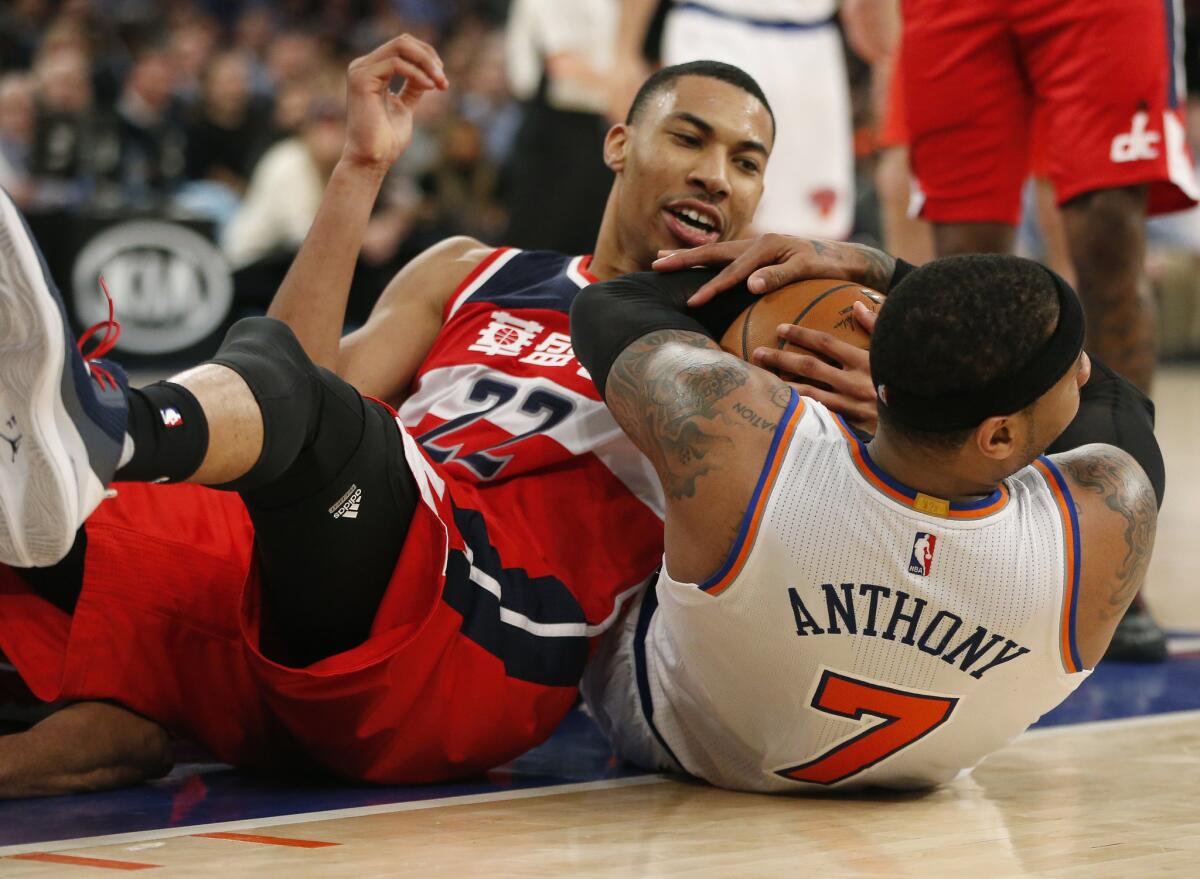 Wizards forward Otto Porter Jr. and Knicks forward Carmelo Anthony get tangled up after going for a loose ball during the second half of a game on Feb. 9.