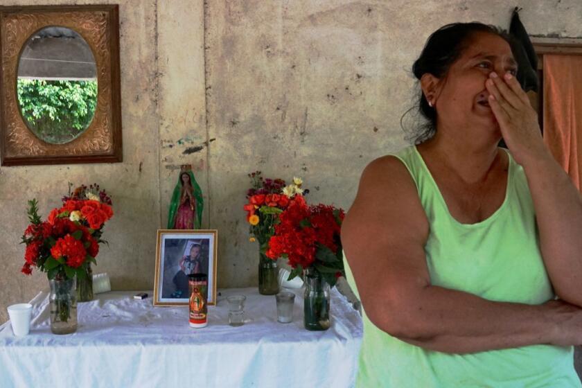 Celia Alicia Ochoa Aguilar,50 mourns for her deceased granddaughter, Juana Anastasia Miranda Aguilar, 3, at her home in village of Valle Lirio, western Guatemala. The young girl was among 4 Guatemalans, including 3 children, found deceased on June 23 near the Rio Grande outside McAllen, Texas, apparently having succumbed to dehydration. Ms. Ochoa Aguilar's daughter, Neily Yoseli Aguilar Ochoa, survived the tragedy and is in U.S. custody, the family says. Photos , flowers candles , black ribbons in altar at home in honor of deceased grand-daughter.