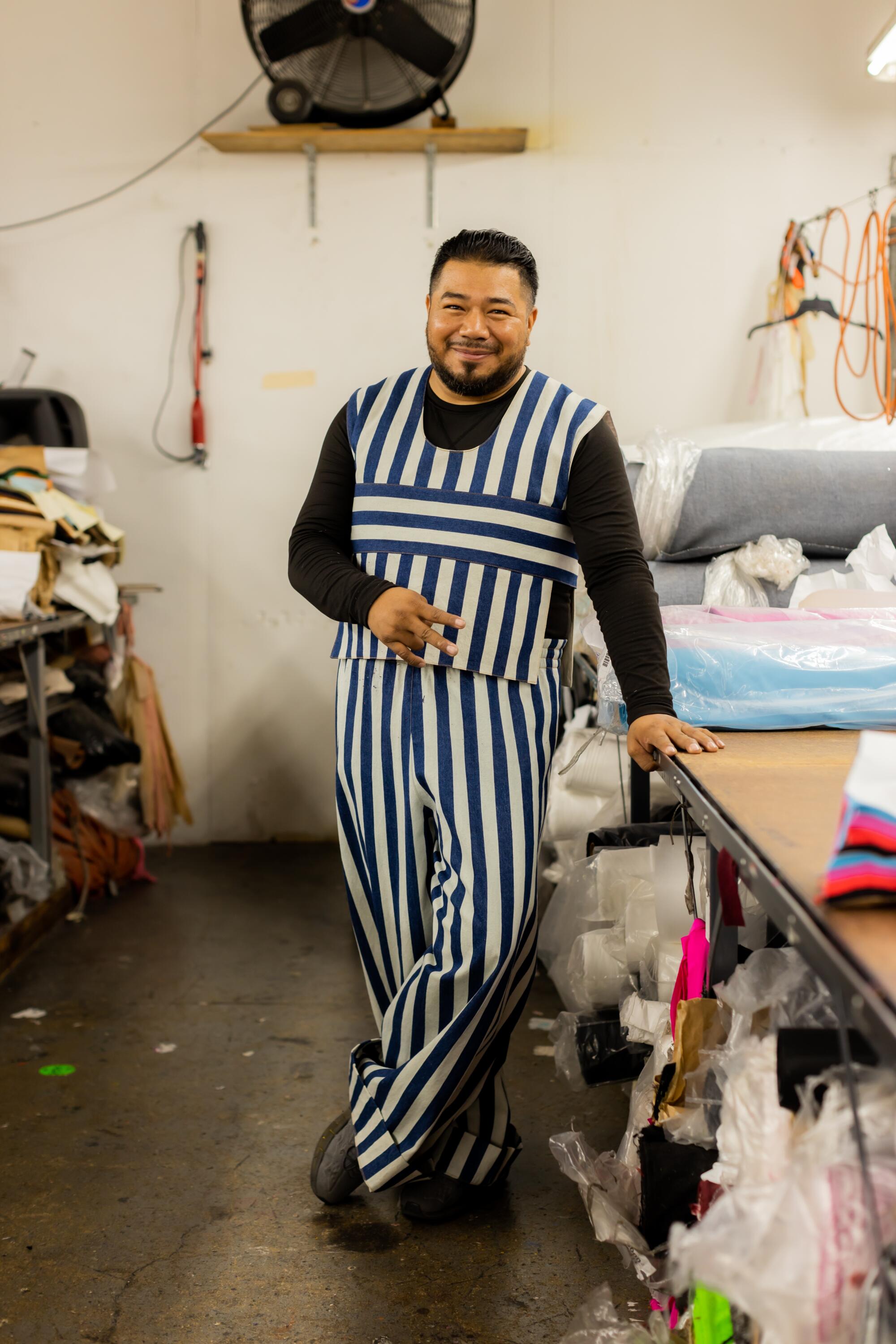 Photo of Rolas wearing a Nancy Stella Soto leisure uniform and his own undershirts.