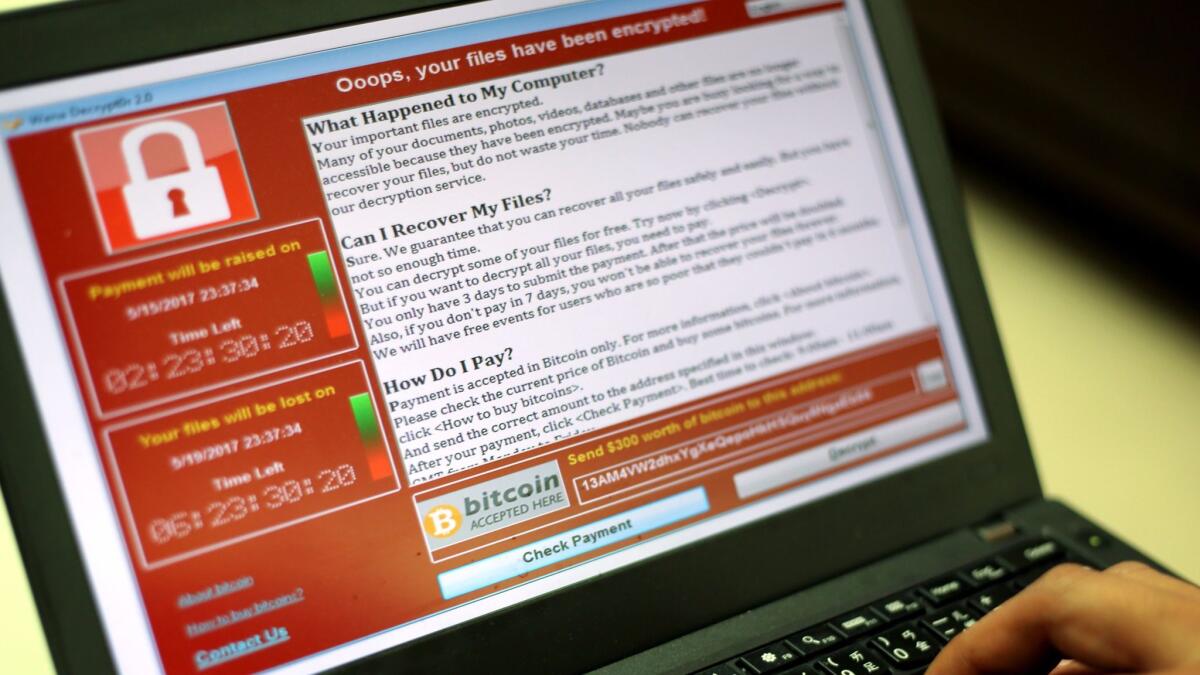 A programer shows a sample of a ransomware cyberattack on a laptop in Taipei, Taiwan, 13 May, 2017.