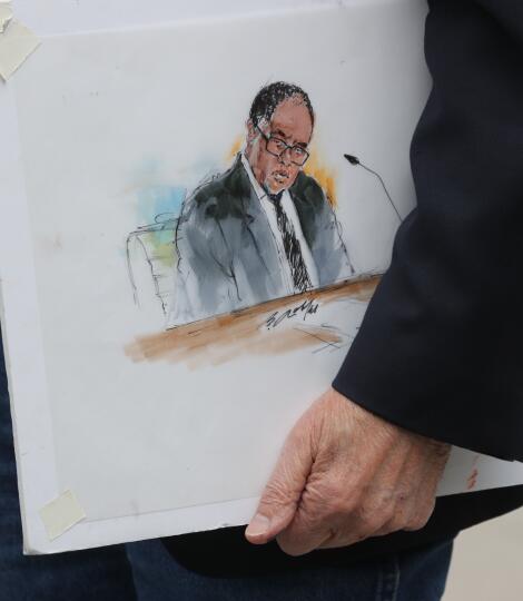 A courtroom artist holds a rendering of suspended Los Angeles City Councilmember Mark Ridley-Thomas