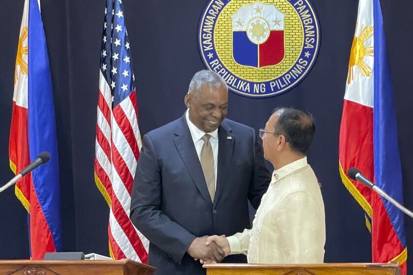 U.S. Defense Secretary Lloyd Austin, left, shakes hands with his Philippine counterpart, Carlito Galvez Jr. at a joint press conference in Camp Aguinaldo military headquarters in metro Manila, Philippines on Thursday, Feb. 2, 2023. The United States and the Philippines announced on Thursday an agreement to expand American military presence in the Southeast Asian country, where U.S. forces would be granted access to four more Philippine military camps, effectively giving them new ground to ramp up deterrence against China's increasingly aggressive actions toward Taiwan and in the disputed South China Sea. (AP Photo/Joeal Calupitan,Pool)