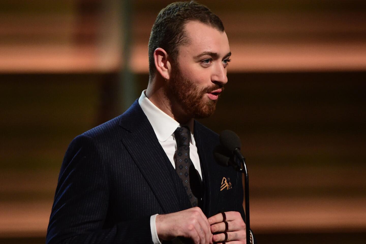 Sam Smith presents the award for best new artist onstage.