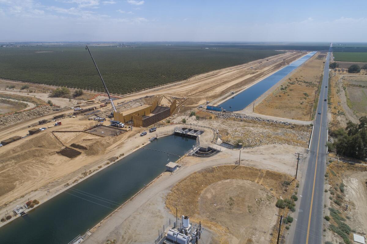 Construction continues on a section of the Friant-Kern Canal damaged from subsidence.