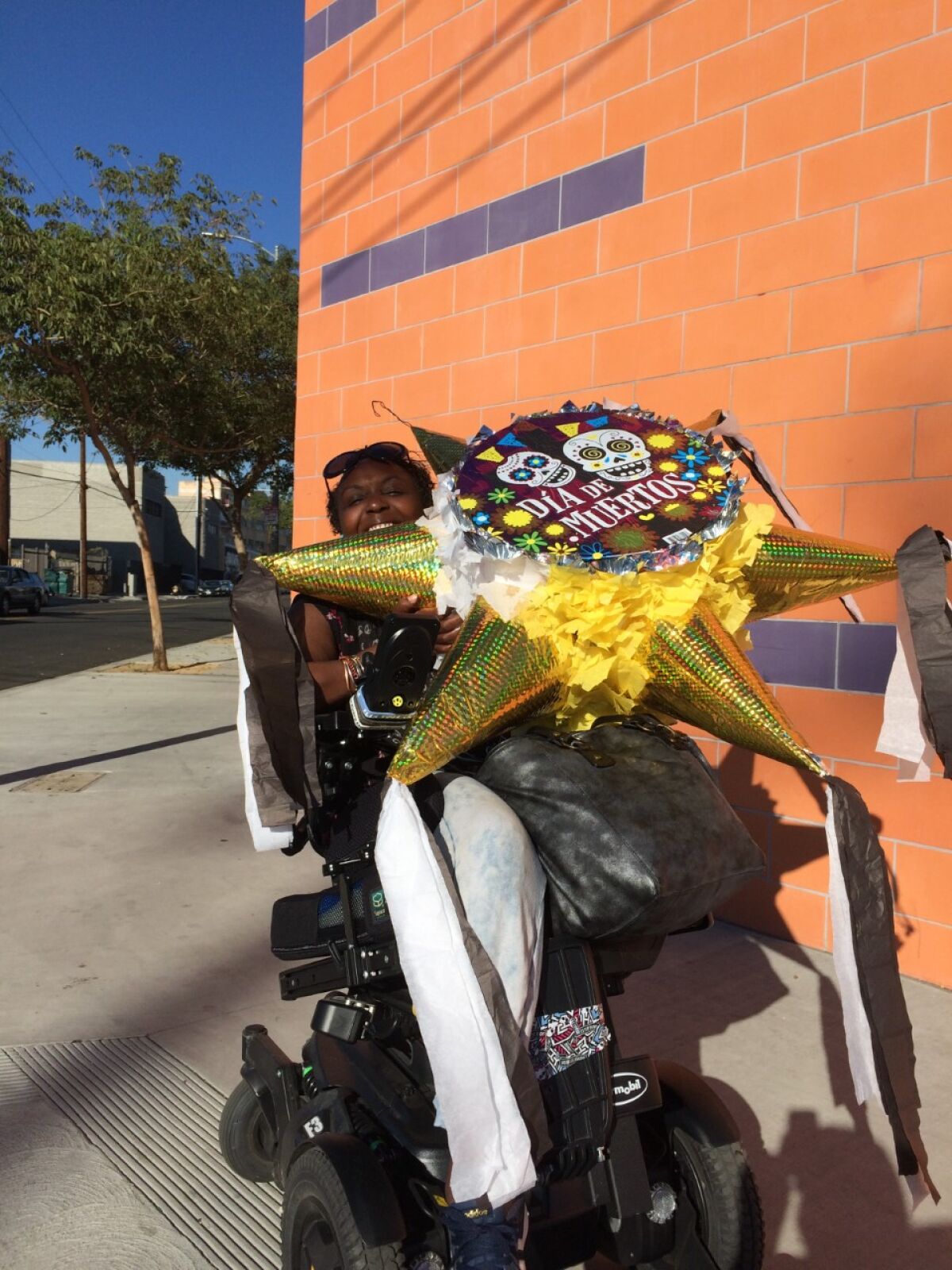 Engracia Figueroa carries a piñata back from an L.A. shop for a Communities Actively Living Independent and Free fundraiser.
