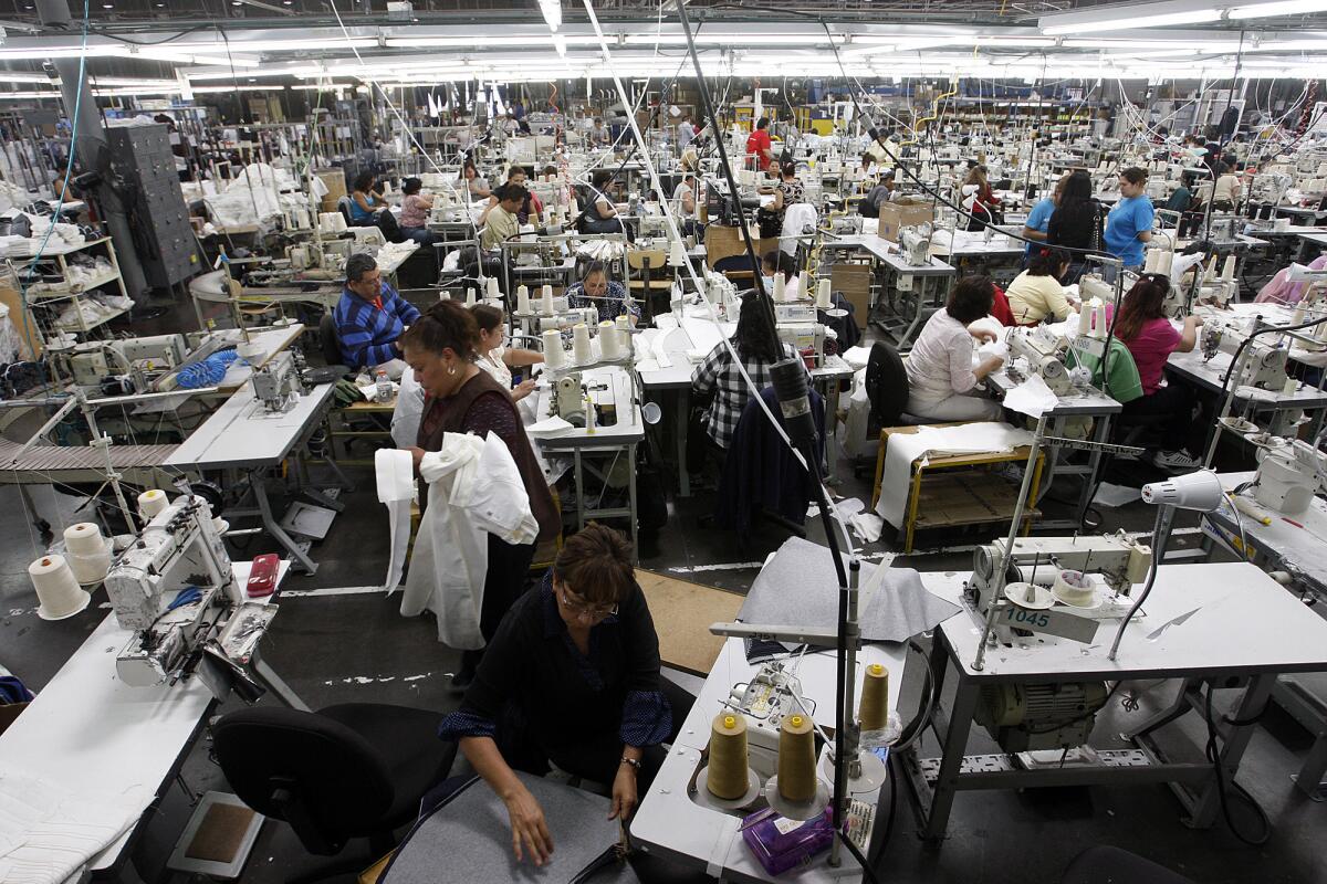 Manufacturing in the U.S. has become more competitive over the past decade compared with rivals such as China and Russia. Shown here at workers in an American Apparel garment dye factory in Southgate in 2012.