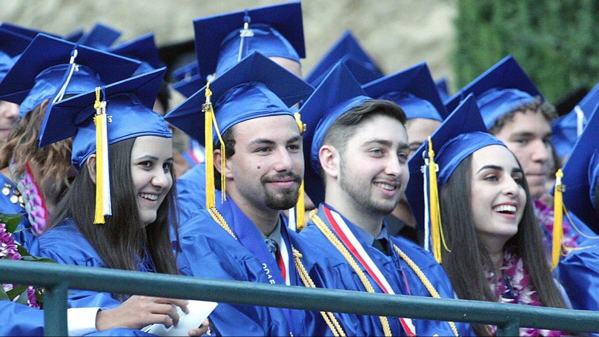 Students smile and laugh at valedictorian Daniel Ragheb's speech at the class 0f 2016 graduation ceremony.