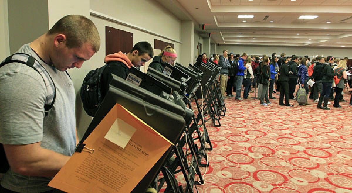 Voters stand in line waiting to cast their ballot at a polling station in Columbus, Ohio.