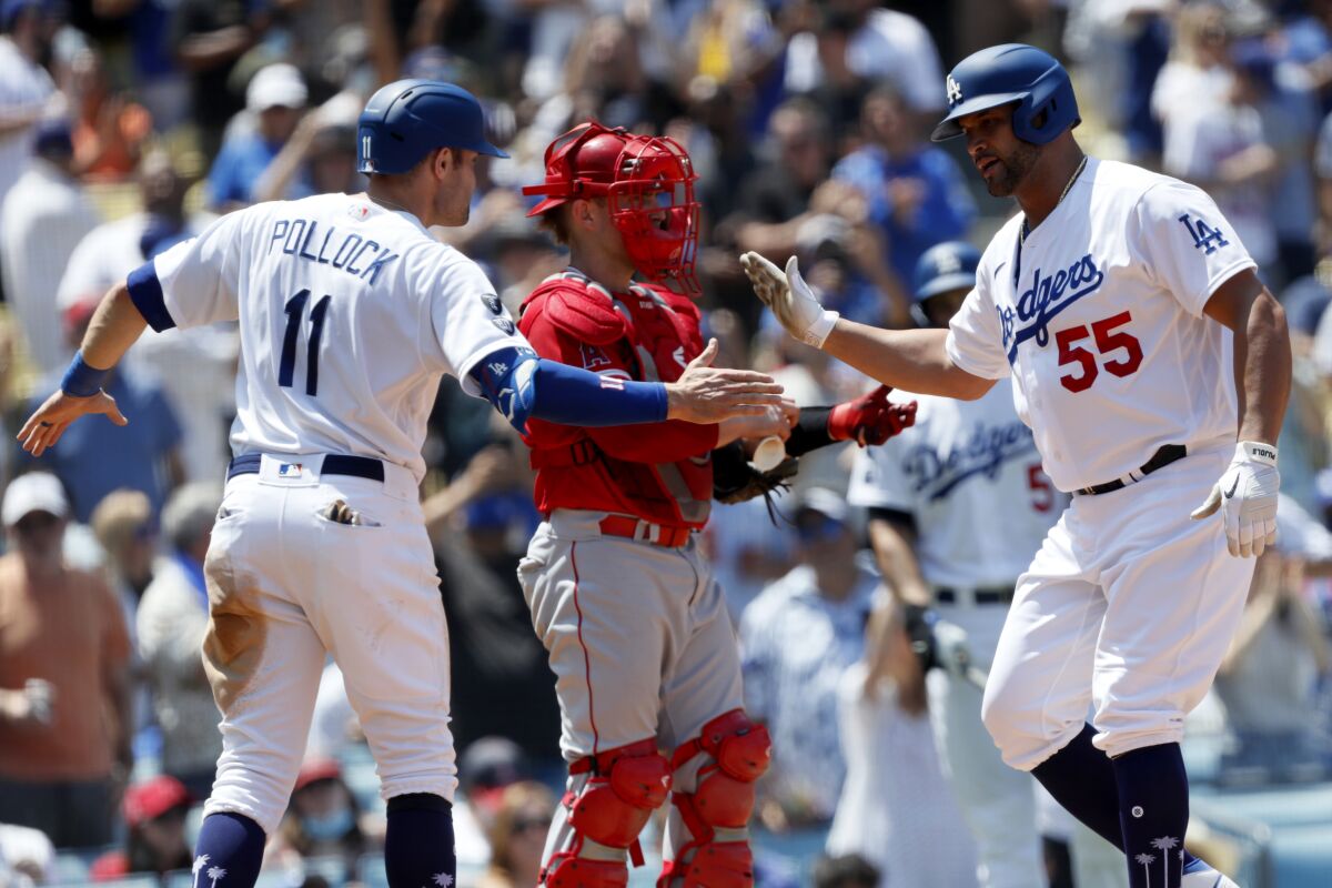 Albert Pujols, right, celebrates his two-run home run with Dodgers teammate AJ Pollock.