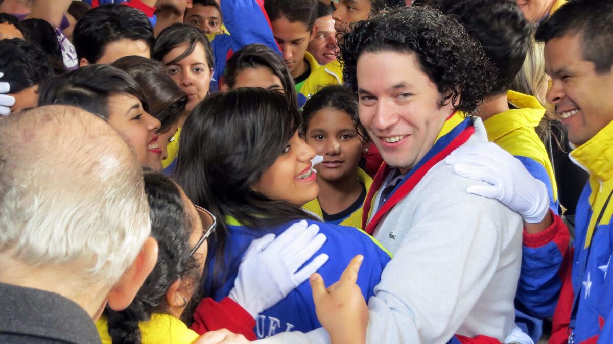 Gustavo Dudamel among students at a 2012 showcase performance of El Sistema students in Caracas, Venezuela.