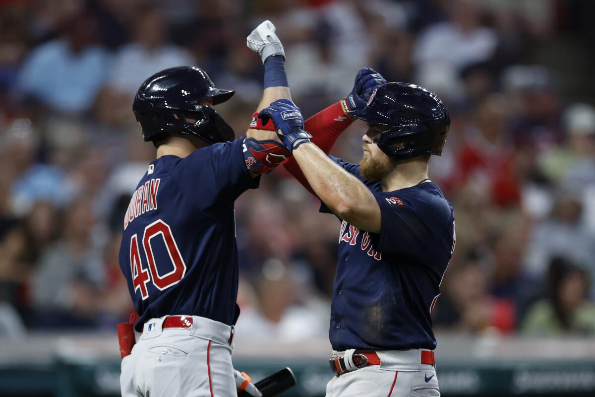 Boston Red Sox's Christian Arroyo, right, celebrates with Jarren Duran after hitting a two-run home run against the Cleveland Guardians during the seventh inning of a baseball game Friday, June 24, 2022, in Cleveland. (AP Photo/Ron Schwane)