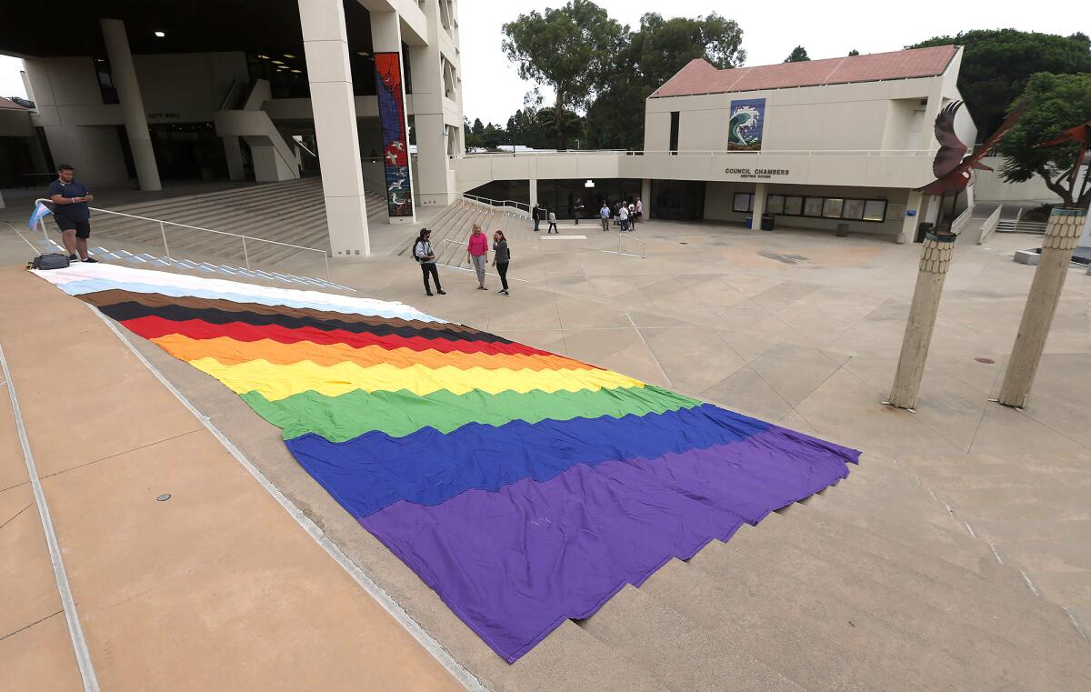 The Pride of the Pier group rolled out a huge Pride flag on the steps of Huntington Beach City Hall.