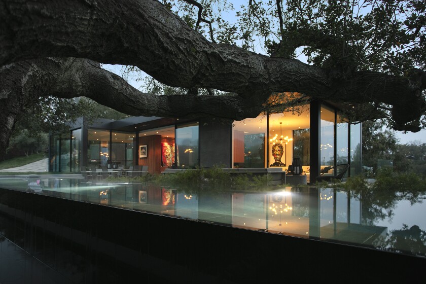 In the 9600 block of Oak Pass Road in Beverly Crest, a limited liability company tied to Chinese filmmaker James Wang sold a modern showplace for $22.5 million.