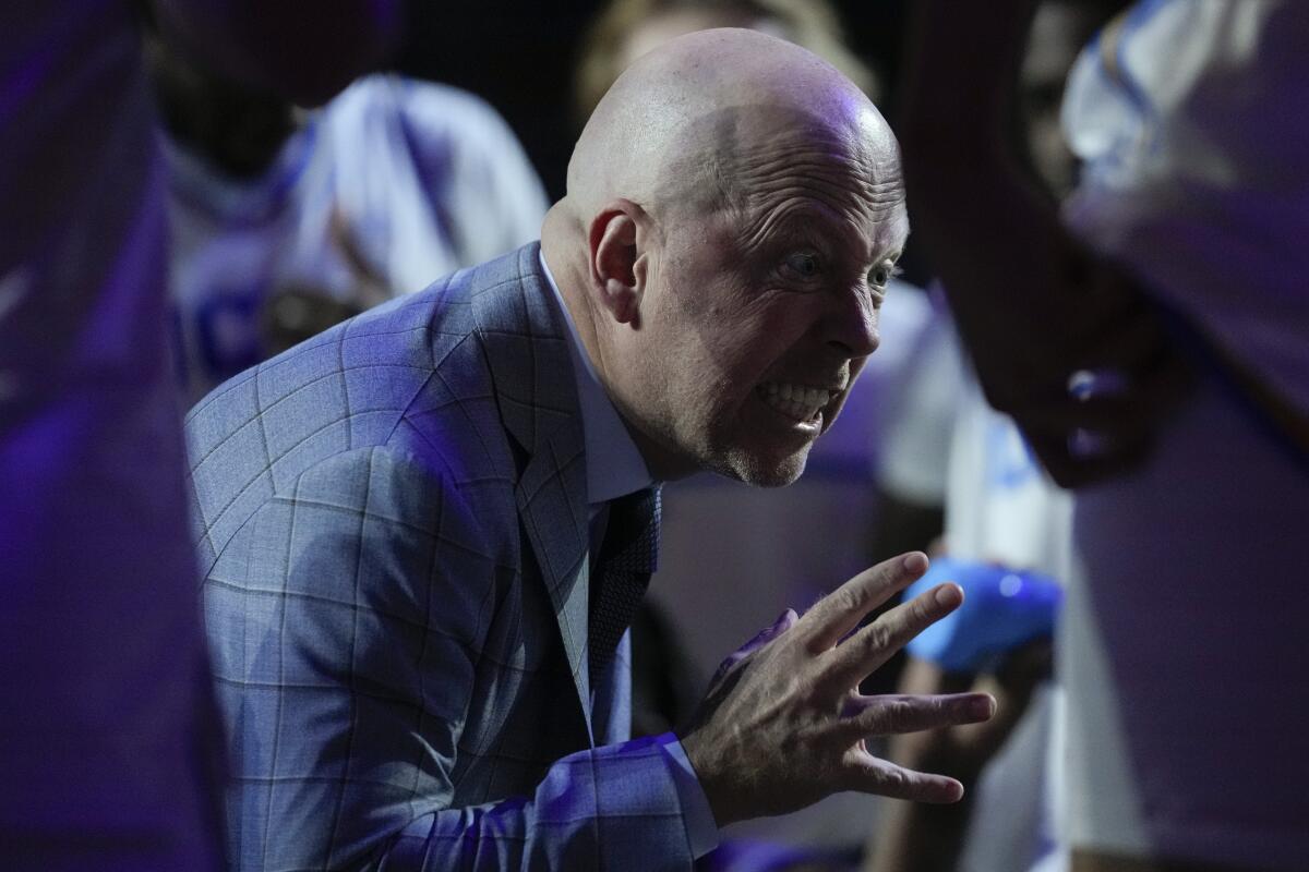 UCLA head coach Mick Cronin talks with players during a timeout in the second half.