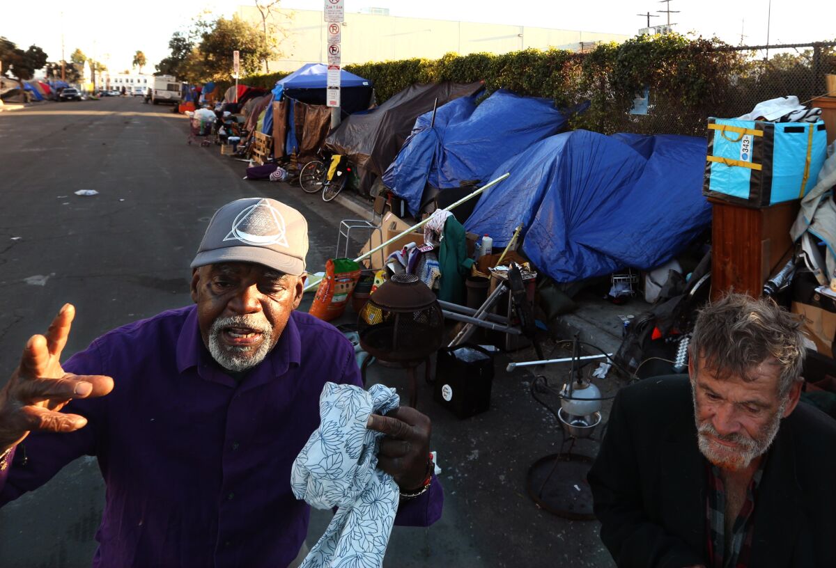 Rayton "Simba" White, 65, left, shares his views about Project Roomkey, next to Bill Greene, 62.