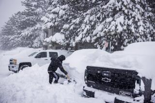 A person tries to dig their car out of a snow bank in Mammoth Lakes. The mountain has received 40 - 54 inches from the latest storm and has already surpassed last year's season snowfall total of 310 inches at the Main Lodge and 419 inches at the summit.