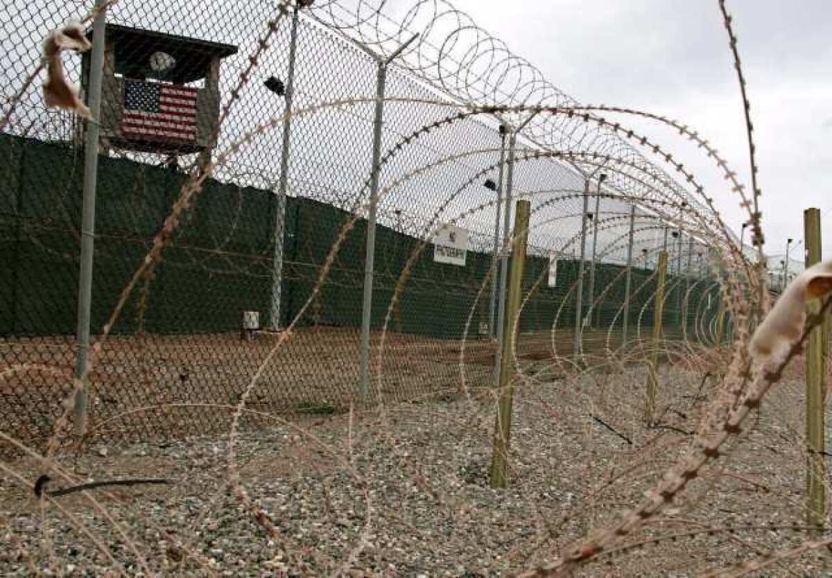 This 2006 photo shows guard towers and triple rows of razor barbed wire perimeter for Camp Delta at Guantanamo Bay, where alleged enemy combatants captured in Afghanistan are being detained.