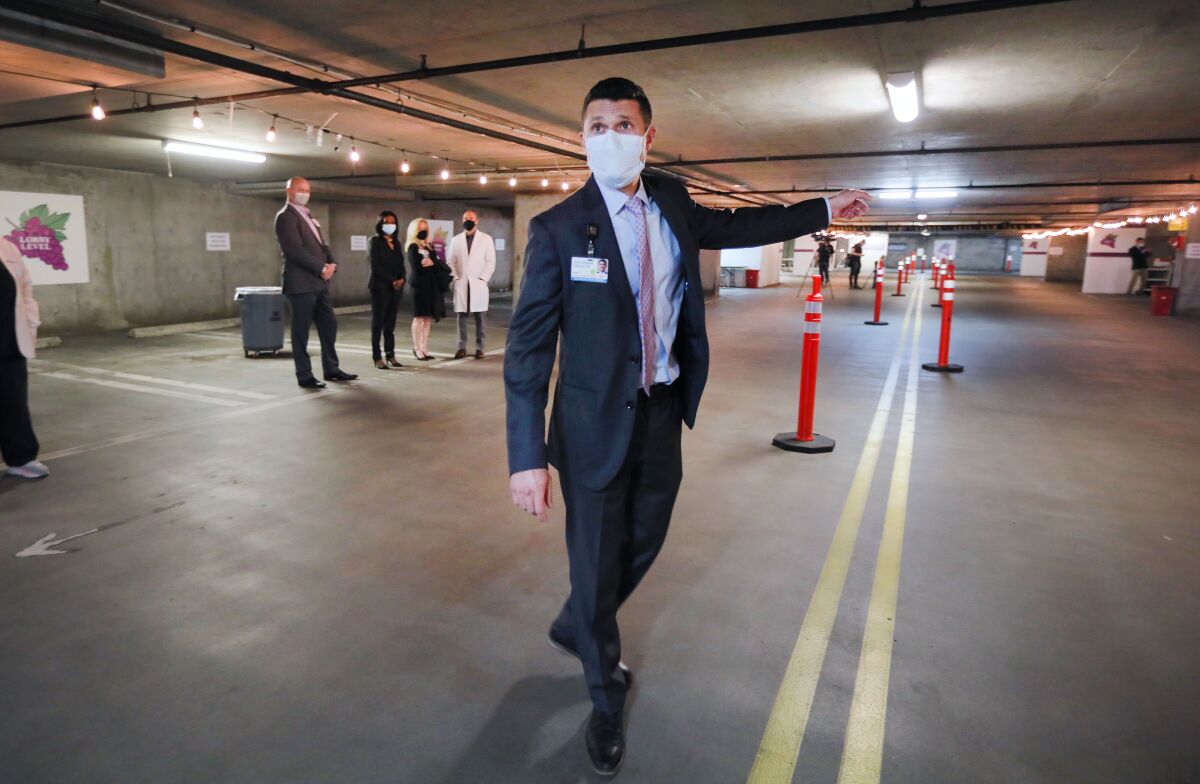 Brian Cohen of Palomar Health leads a tour of the COVID-19 vaccine station at the former Palomar Medical Center.