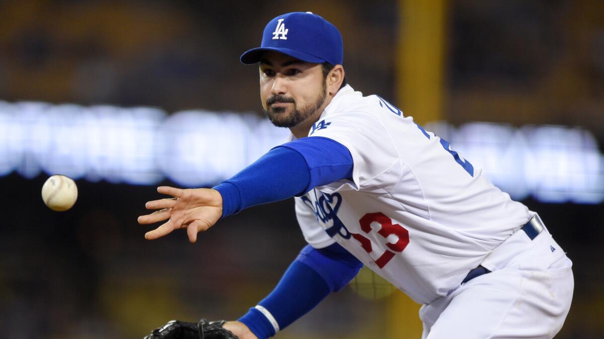 Dodgers first baseman Adrian Gonzalez tosses the ball during a game against the Atlanta Braves on May 26, 2015.