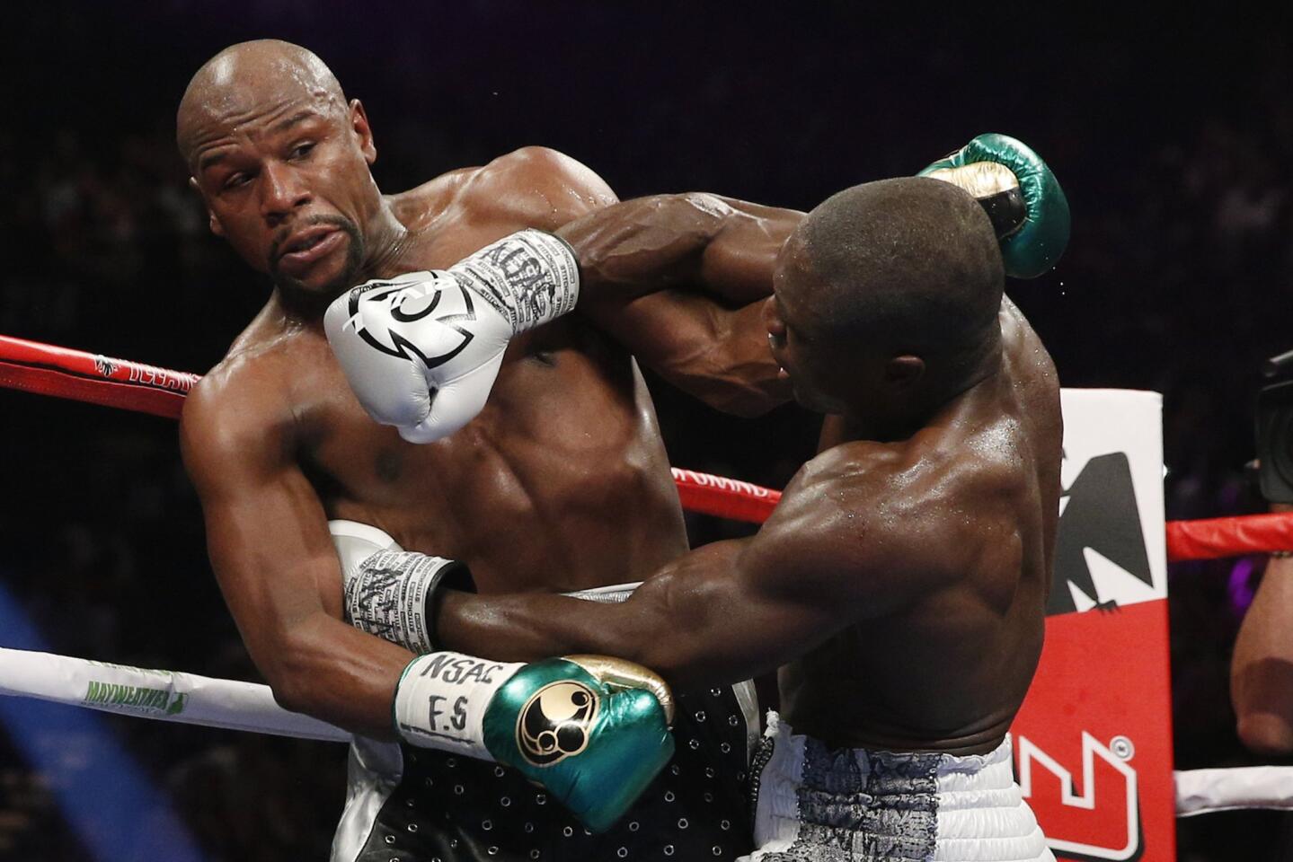Andre Berto, right, lands a right to the head of Floyd Mayweather Jr. during their welterweight title boxing bout Saturday.