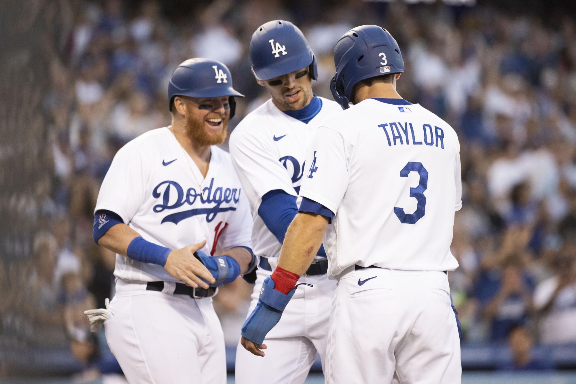 Dodgers Justin Turner, Trayce Thompson and Chris Taylor celebrate Thompson's three-run home run against the Rockies