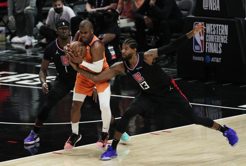 Clippers forward tries to steal the ball from Suns guard Chris Paul.