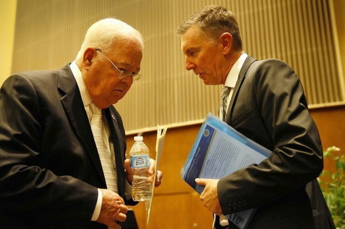 L.A. Unified board President Richard Vladovic confers with Supt. John Deasy last month. Deasy reportedly threatened to quit if Vladovic got the top job.