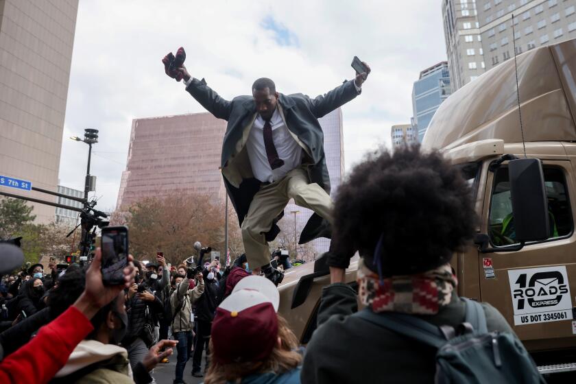 MINNEAPOLIS, MINNESOTA - APRIL 20: A man jumps down from a truck which had attempted to make its way past the crowd as people react after the verdict was read in the Derek Chauvin trial on April 20, 2021 In Minneapolis, Minnesota. Former police officer Derek Chauvin was on trial on second-degree murder, third-degree murder and second-degree manslaughter charges in the death of George Floyd May 25, 2020. After video was released of then-officer Chauvin kneeling on Floyd’s neck for nine minutes and twenty-nine seconds, protests broke out across the U.S. and around the world. The jury found Chauvin guilty on all three charges. (Photo by Scott Olson/Getty Images)