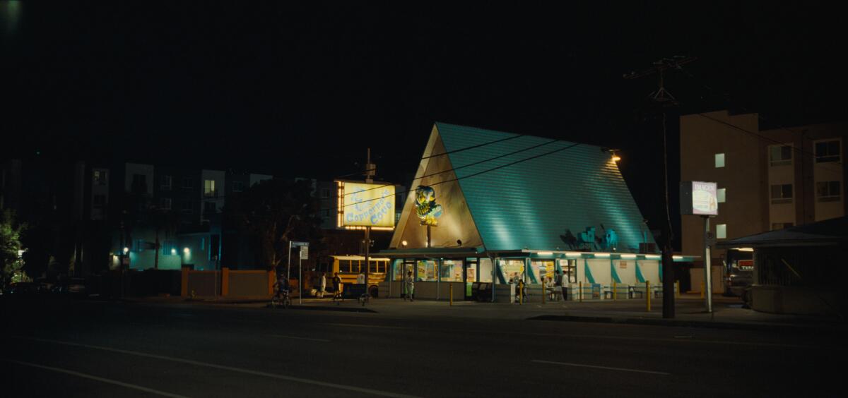 An A-frame fried fish restaurant lit up at night