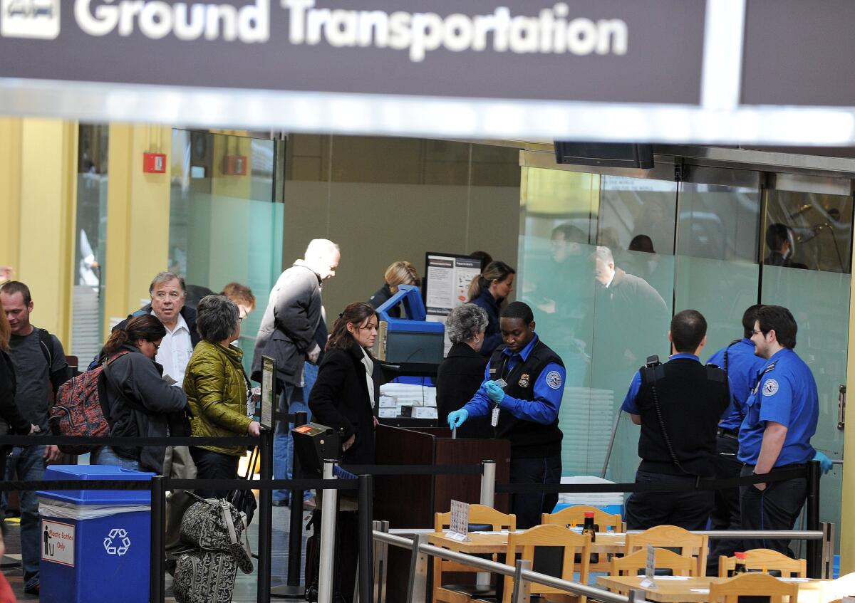 Starting Jan. 22, 2018, travelers with licenses issued by states that have yet to comply with the new ID standards won't be allowed to board a domestic flight in the U.S. unless they have an alternative form of identification. Above, TSA personnel at the Ronald Reagan National Airport in Washington.