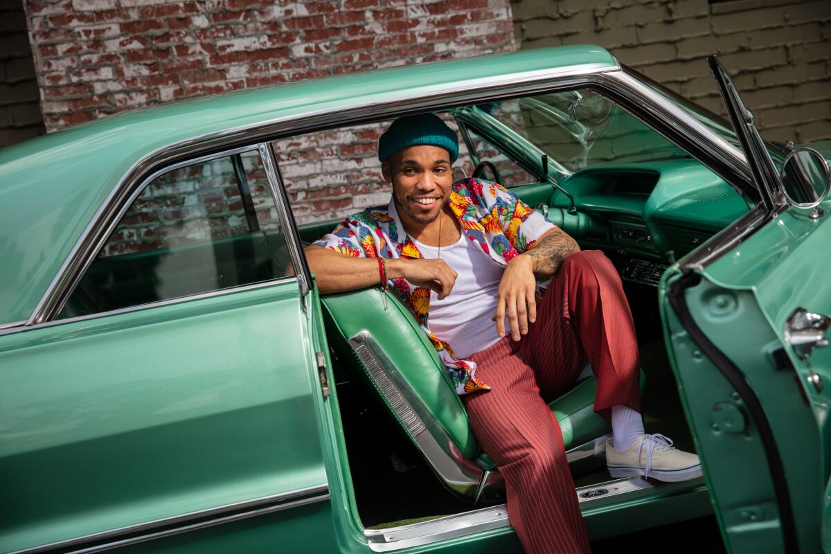 Anderson .Paak, the genre-stretching musician, sits in his green 1963 Impala in this 2019 photo.