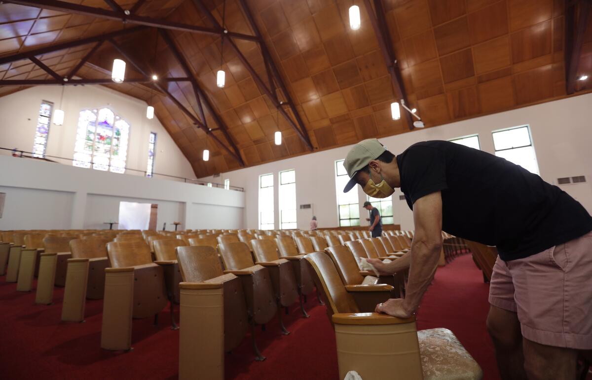 Alamo Heights Baptist Church pastor Bobby Contreras works to clean, sanitize and prepare his church for services in San Antonio, Texas.