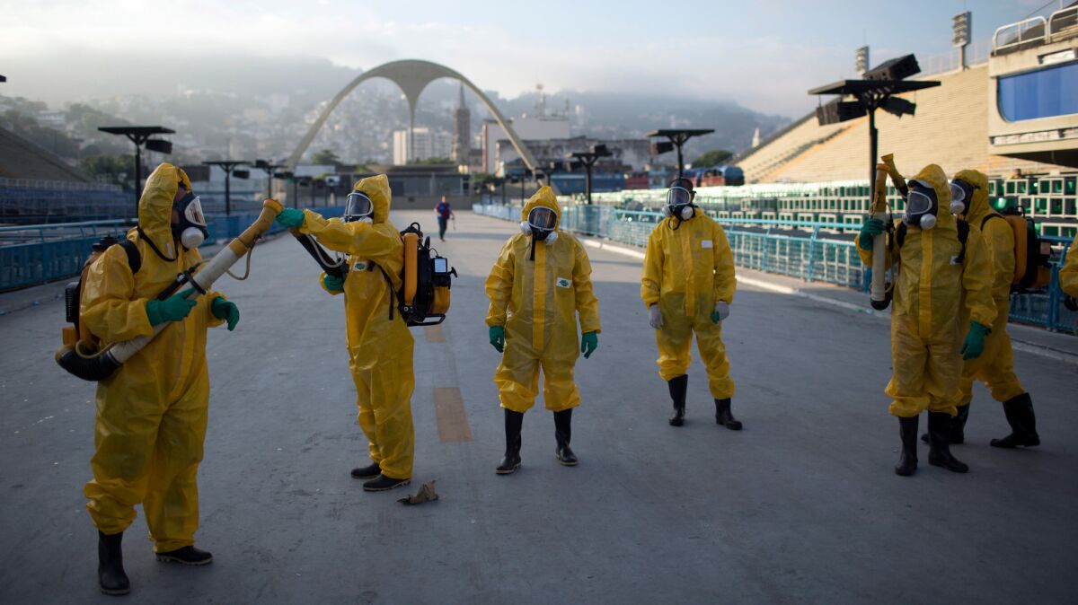 Health workers get ready to spray insecticide to combat the mosquitoes that transmits the Zika virus, under the bleachers of the Sambadrome in Rio de Janeiro in January.
