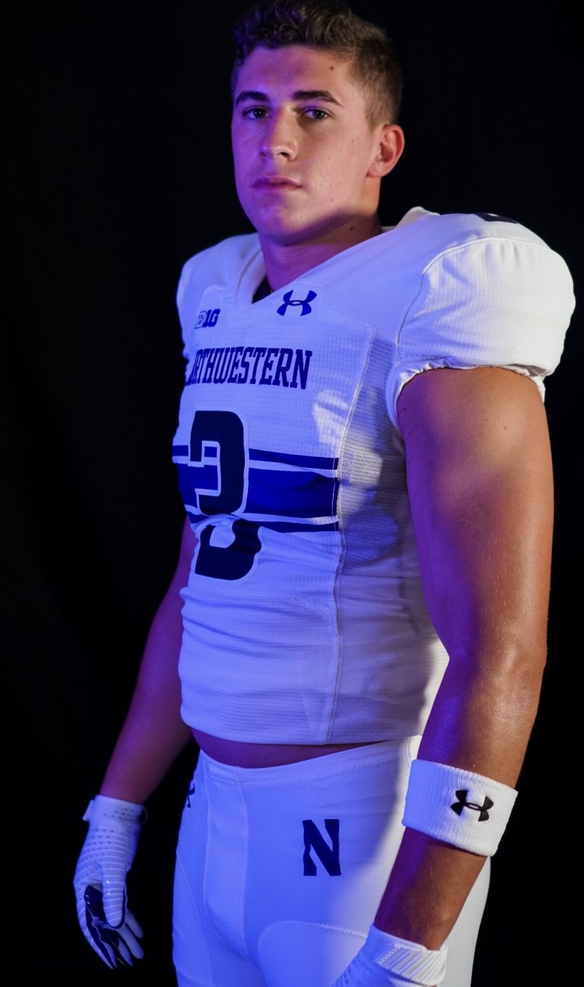 Glendora High linebacker Braydon Brus poses for a photo in a Northwestern jersey, the college to which he committed.
