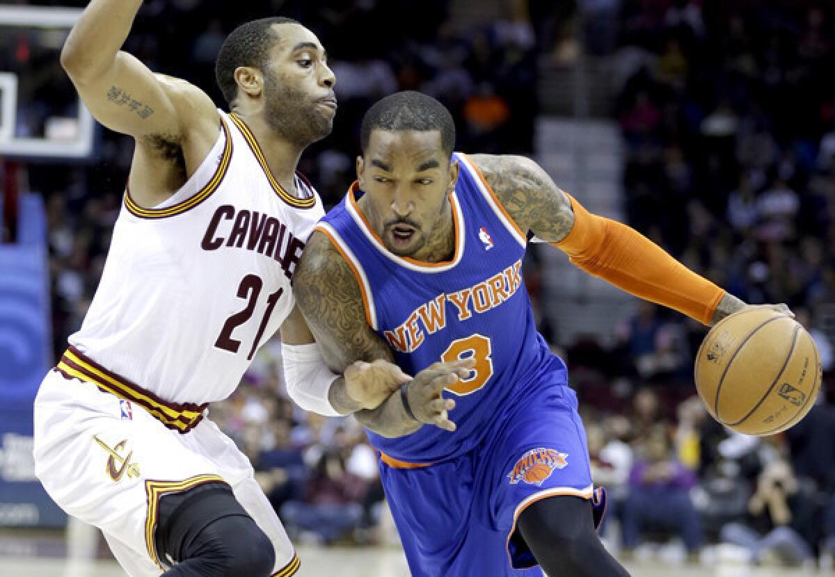 Knicks guard J.R. Smith drives against Cavaliers guard Wayne Ellington during a game in Cleveland.