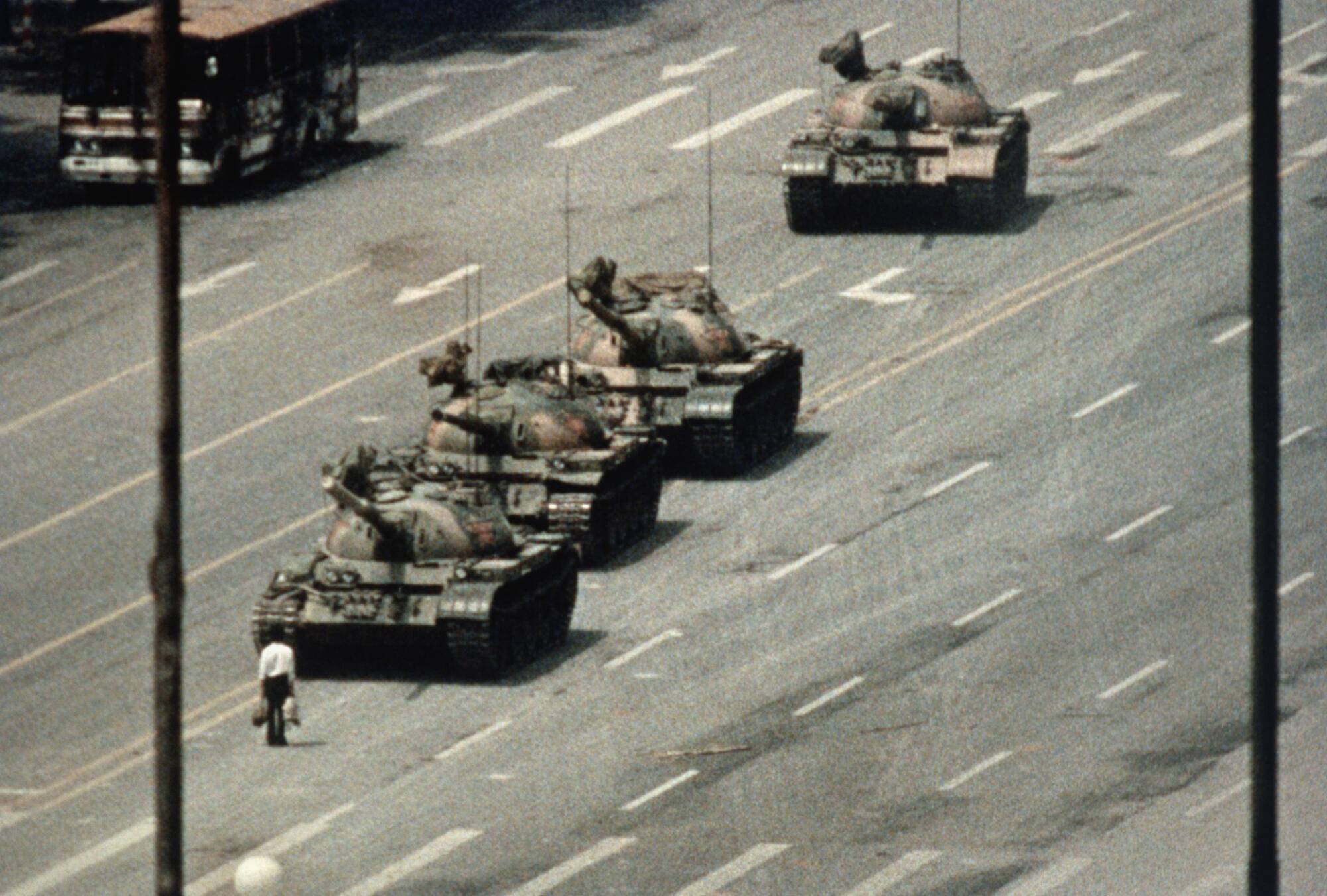 A Beijing demonstrator blocks the path of a tank convoy along the Avenue of Eternal Peace near Tiananmen Square