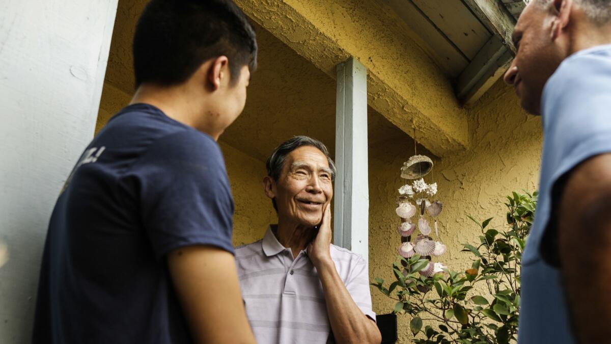 Wen Lou, 71, tells Democrat Gil Cisneros, right, that he's already cast a mail ballot for him the 39th Congressional District.