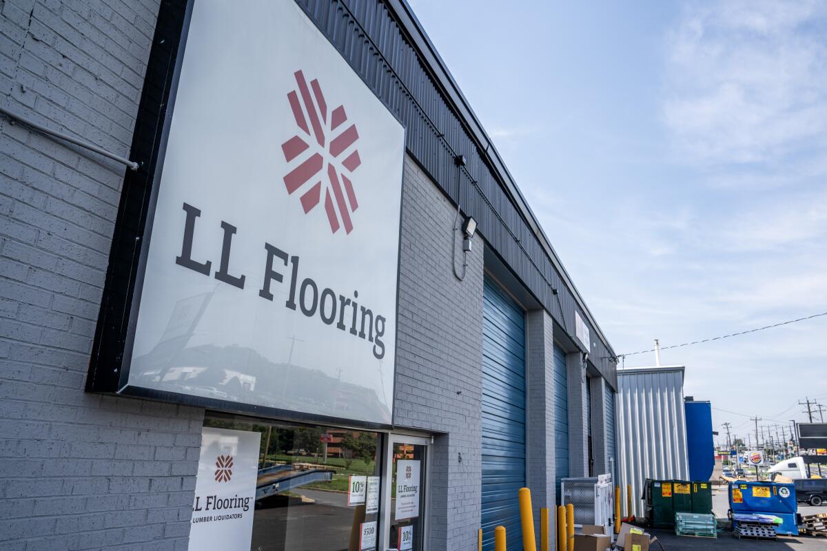 A sign on a building says "LL Flooring."