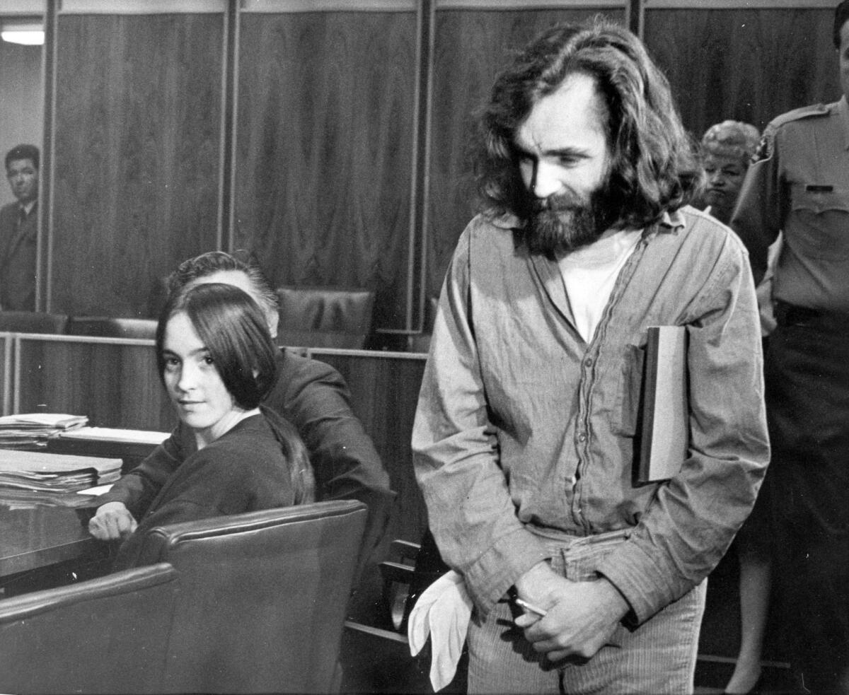 Susan Atkins, left, looks back as Charles Manson is led into court in Santa Monica in 1970.
