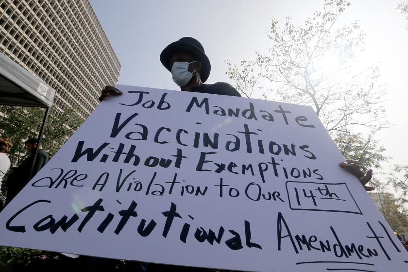 LOS ANGELES, CALIF. - NOV. 8, 2021. A protester opposed to vaccination madates protests at Grand Park in downtown Los Angeles on Monday, Nov. 8, 2021. Firefighters 4 Freedom hosted the "March for Freedom" rally in support of workers affected by the vaccine mandates in Los Angeles. (Luis Sinco / Los Angeles Times)