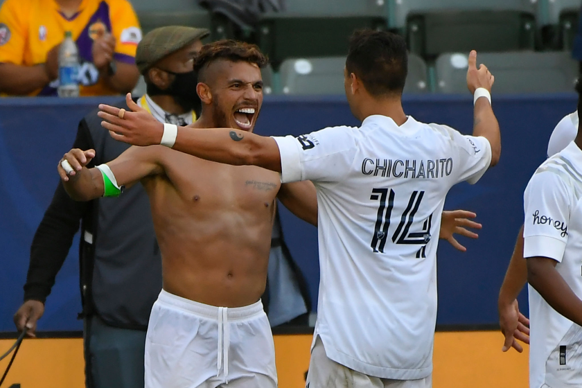 Jonathan dos Santos is shirtless as Galaxy teammate Javier Hernandez congratulates him on his goal May 8, 2021.
