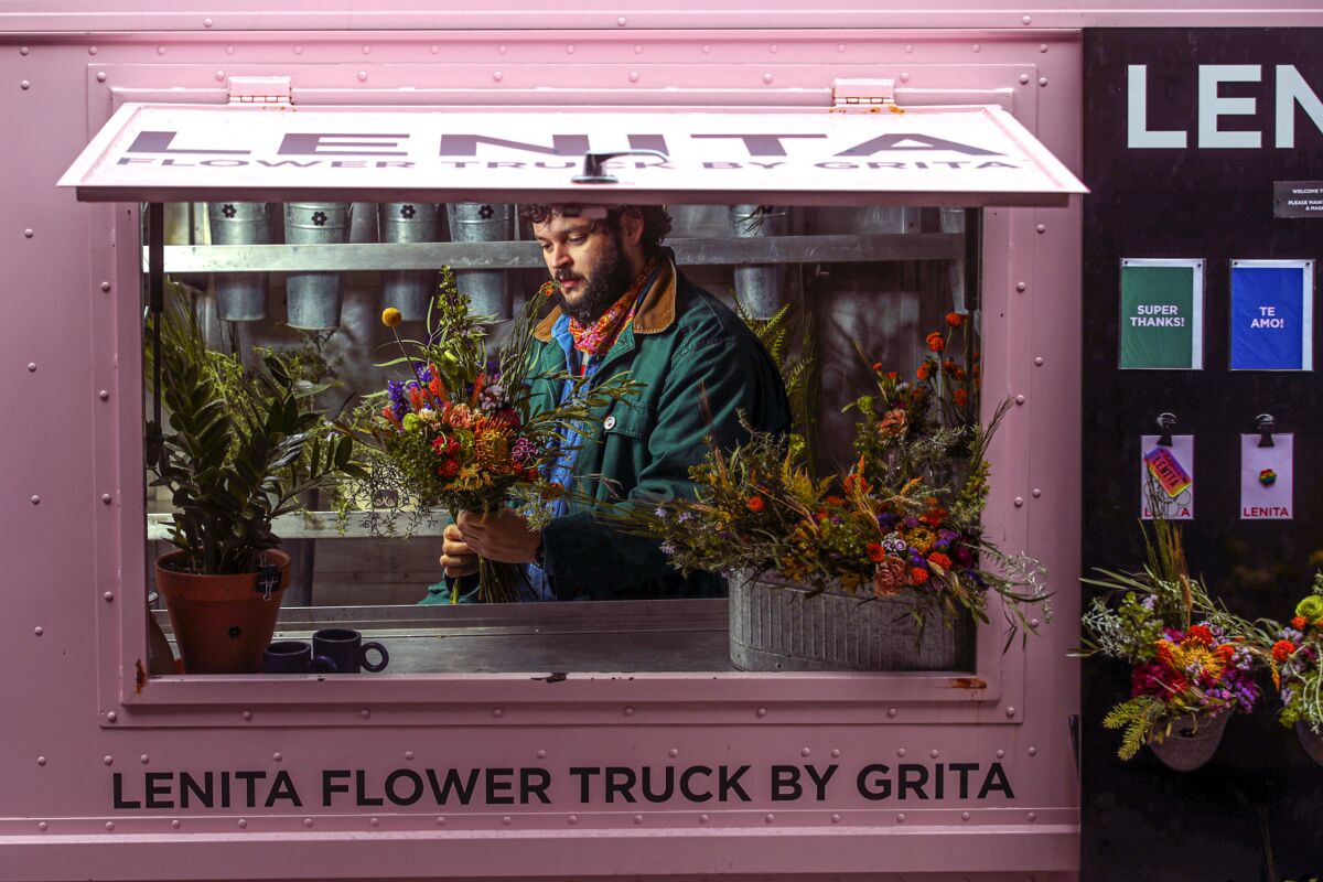 Nemuel DePaula creates floral bouquets in his pink Lenita by Grita flower truck.