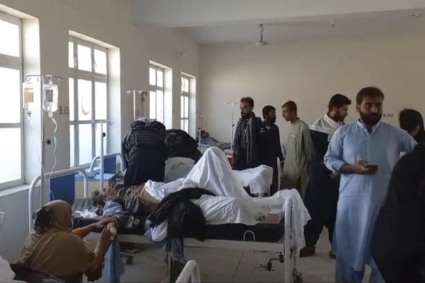 In this photo provided by District Police Office, injured victims of bomb explosion are treated at a hospital, in Mastung near Quetta, Pakistan, Friday, Sept. 29, 2023. A powerful bomb exploded at a rally celebrating the birthday of Islam's Prophet Muhammad in southwest Pakistan on Friday, killing multiple people and wounding dozens of others, police and a government official said. (District Police Office via AP)