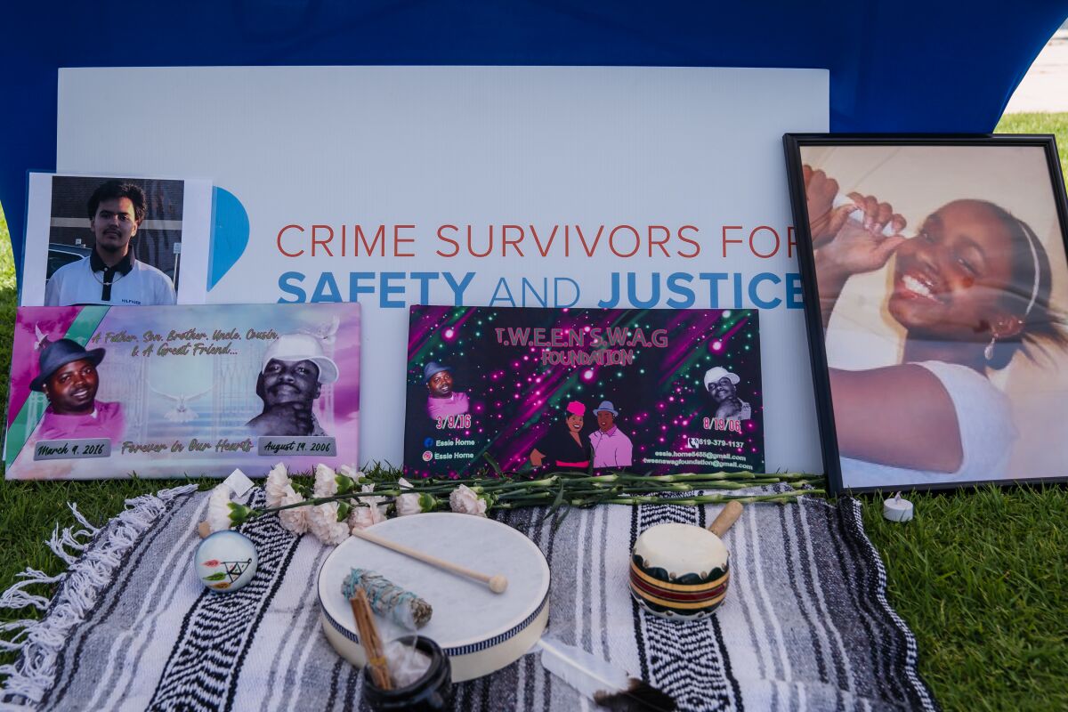 Pictures of people who have been lost to violence can be seen in front of a table at the vigil.