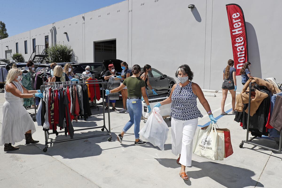 Donors and staff members at Working Wardrobes' new donation center in Irvine on Tuesday. 