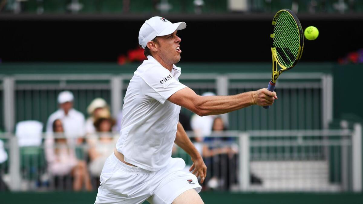 Sam Querrey plays a forehand during his fourth-round match against Tennys Sandgren at Wimbledon on Monday.