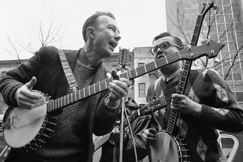 This May 13, 1975, file photo shows folk singer Pete Seeger, left, performing at the Rally for Détente at Carnegie Hall in New York. The American troubadour, folk singer and activist Seeger died Monday Jan. 27, 2014, at age 94.