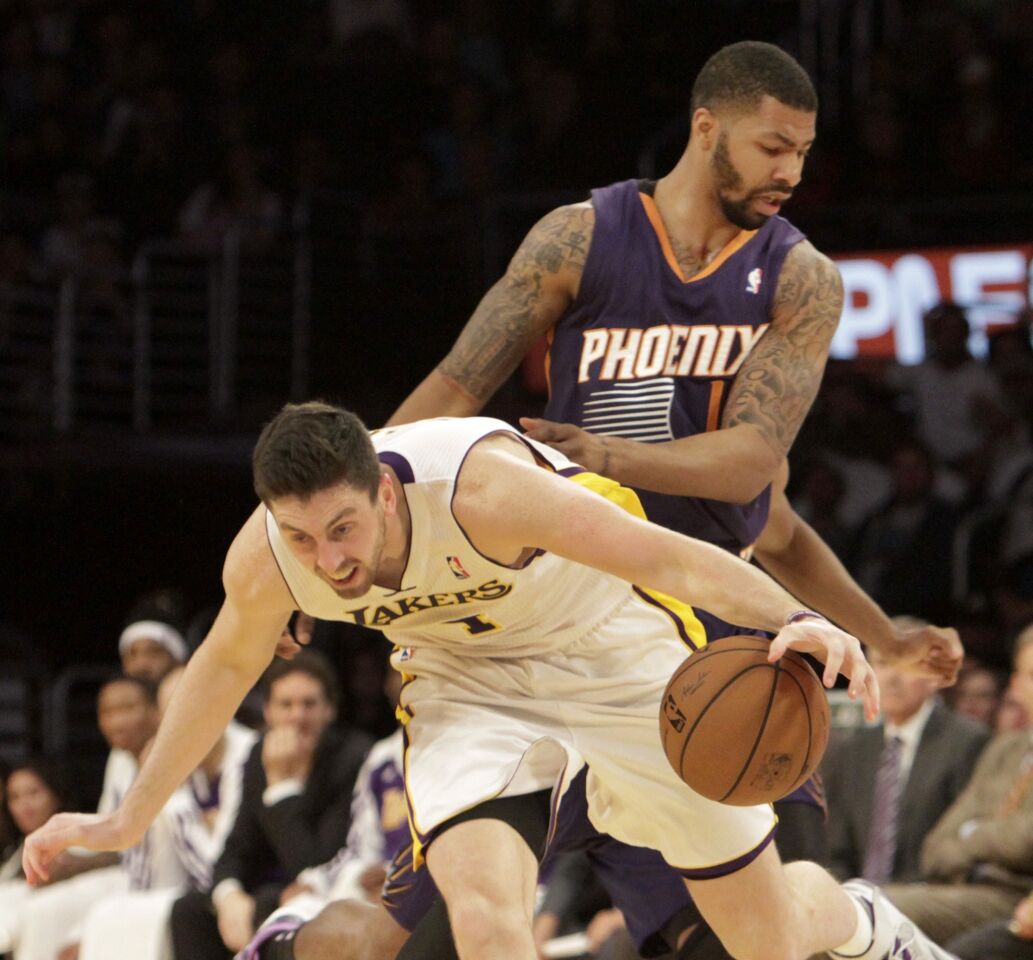 Lakers forward Ryan Kelly, left, is fouled by Phoenix Suns forward Markieff Morris during the second half of the Lakers' 115-99 victory Sunday at Staples Center.
