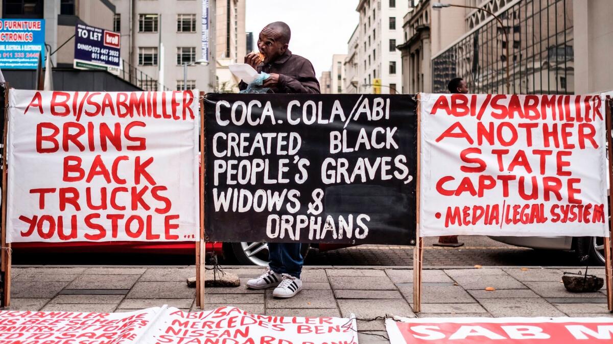 Banners raised by the Marxist group Black First Land First stand outside the High Court in Johannesburg on Friday.